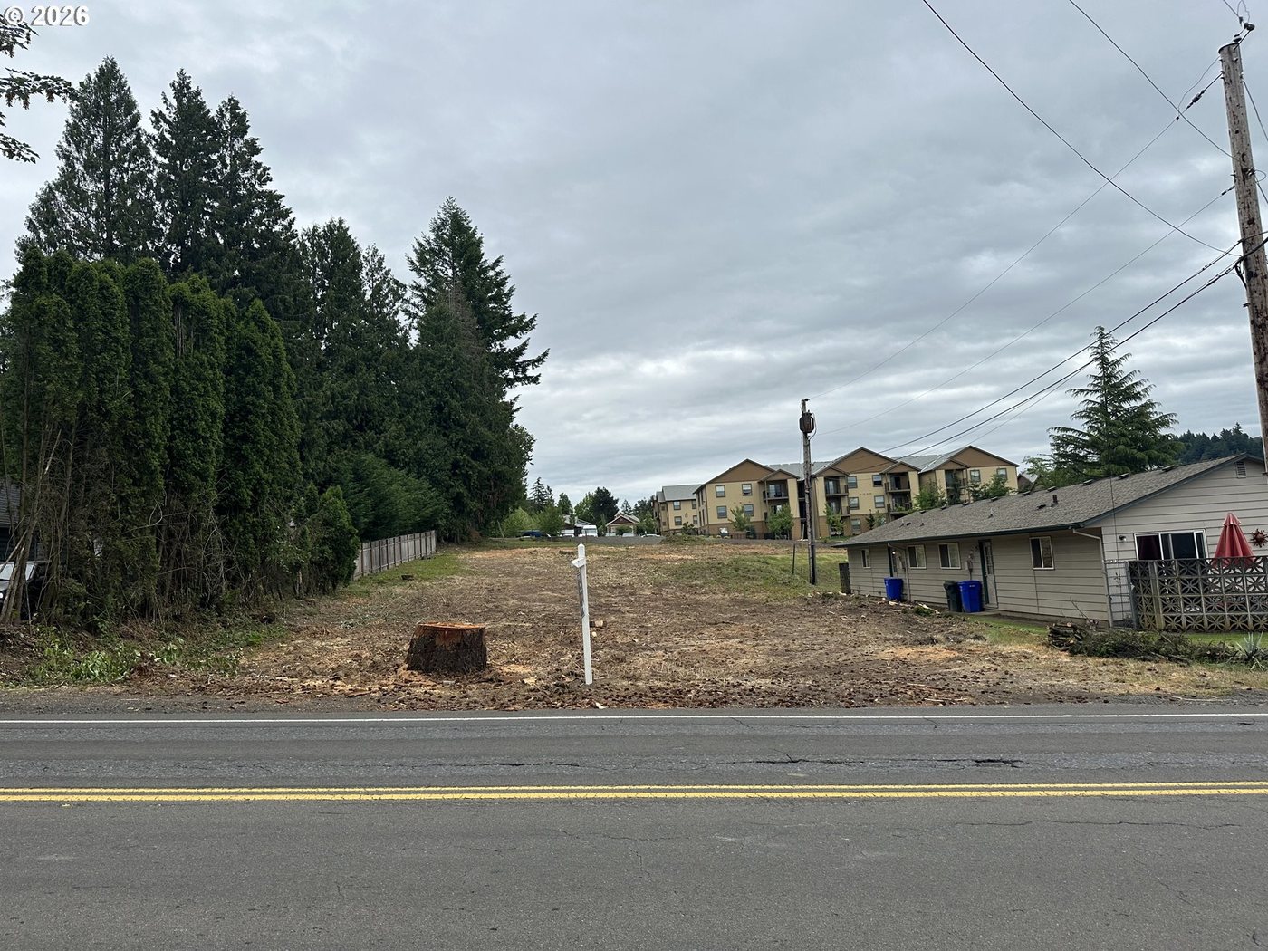 The frontage seen from across the street, stumped and ready to build.